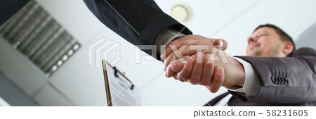 Man in suit shake hand as hello in office Man in suit shake hand as hello in office 58231605