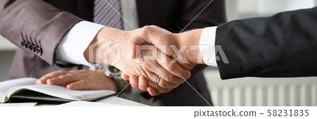 Man in suit shake hand as hello in office Man in suit shake hand as hello in office 58231835