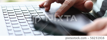 Male arms hold credit card press buttons Male arms hold credit card press buttons 58231916