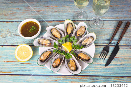 Mussels with herbs with lemon parsley in the table 58233452