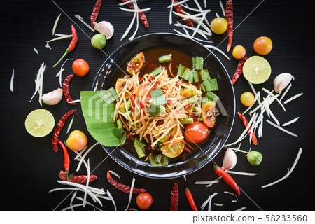 Papaya salad on black plate - Close up of green 58233560