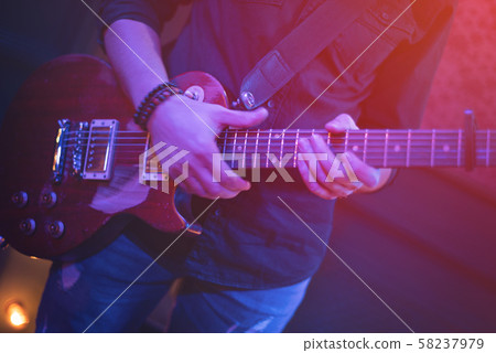 The artist plays the guitar. 58237979