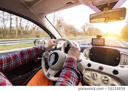 roadtrip - man's hands on the wheel 58238839