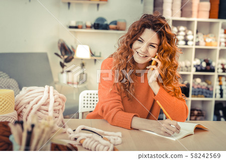 Charming long-haired girl working with great pleasure 58242569