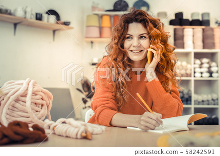 Charming red - haired pretty woman demonstrating her smile 58242591