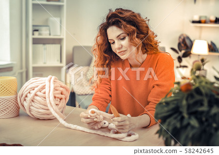 Attractive red - haired girl being deep in thoughts Attractive red - haired girl being deep in thoughts 58242645