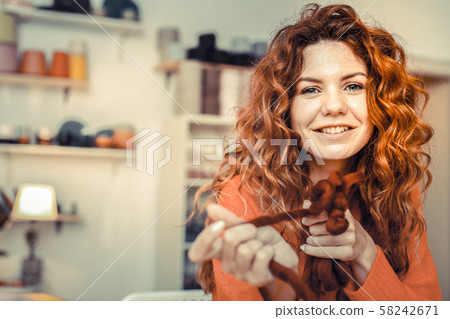Charming young red-haired working with soft yarn Charming young red-haired working with soft yarn 58242671