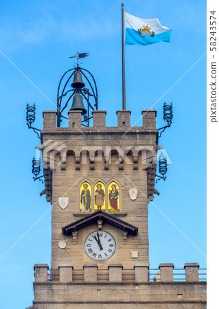 Republic San Marino. National flag on a background of blue sky. Republic San Marino. National flag on a background of blue sky. 58243574