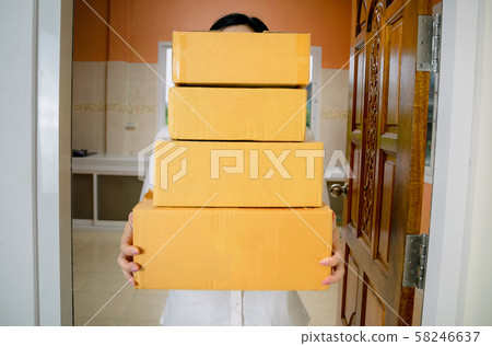 Technology delivery staff uniform handing a parcel box receiving parcel from delivery 58246637