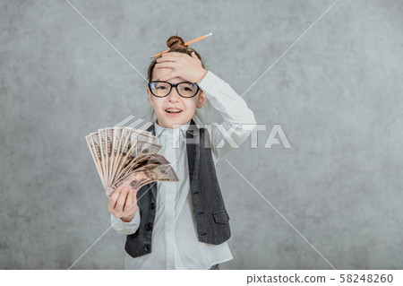 The lady's small business is on a gray background. During this, holds the money in hand. Holds 58248260