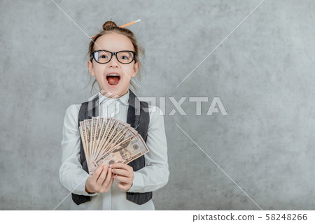 The lady's small business is on a gray background. Close-up During this, holds the money in hand. 58248266