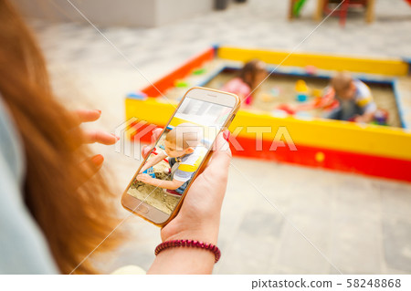 Mother taking photo of her son and posting Mother taking photo of her son and posting 58248868