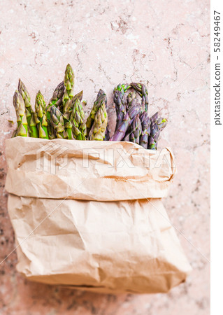 Bunch of fresh purple asparagus spears standing vertical Bunch of fresh purple asparagus spears standing vertical 58249467
