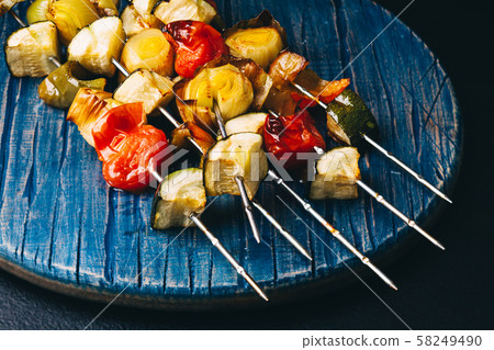 Close up of grilled vegetables on metal skewers Close up of grilled vegetables on metal skewers 58249490