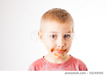 Portrait of fair-haired boy with chocolate on his face isolated on white Portrait of fair-haired boy with chocolate on his face isolated on white 58249495