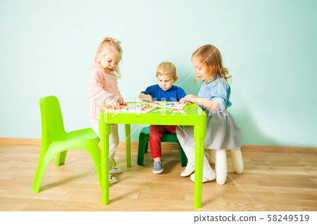 Little child girl playing in kindergarten in Montessori preschool Class. 58249519