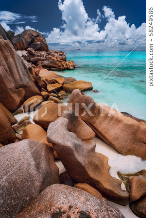 Grande anse located on La Digue island, Seychelles. Sandy beach with orange granite boulders and Grande anse located on La Digue island, Seychelles. Sandy beach with orange granite boulders and 58249586
