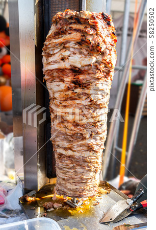 Fast food doner kebab meat on a rotary grill Fast food doner kebab meat on a rotary grill 58250502