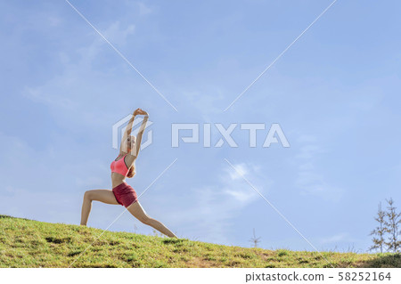 Happy lady doing yoga practice on green hill Happy lady doing yoga practice on green hill 58252164