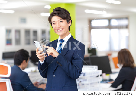 Businessman, office, suit, smartphone 58252172