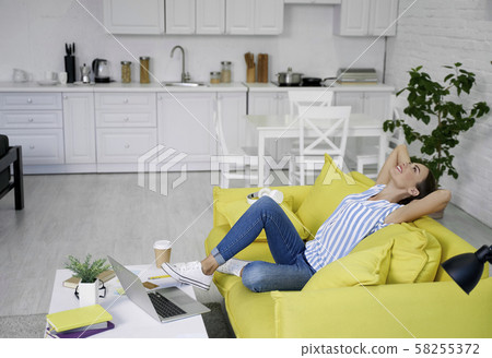 Relaxing on the sofa and smiling stock photo Relaxing on the sofa and smiling stock photo 58255372