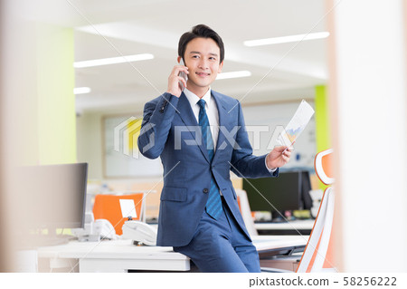 Businessman, office, suit, smartphone Businessman, office, suit, smartphone 58256222