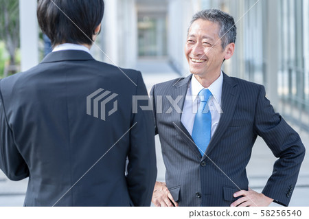 Businessmen standing Businessmen standing 58256540