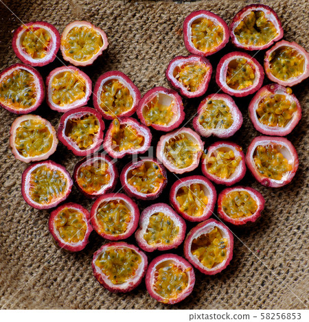 passion fruits cut in half in heart shape background passion fruits cut in half in heart shape background 58256853