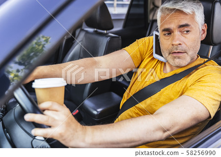 Handsome Caucasian man is driving his car 58256990