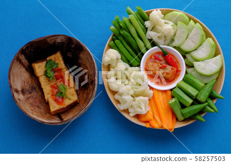 top view tray food, boiled vegetables, tofu, rice on blue background top view tray food, boiled vegetables, tofu, rice on blue background 58257503