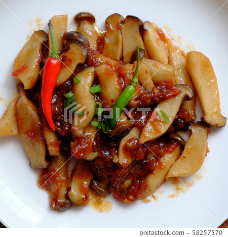 king oyster mushroom cook with tomato sauce on white plate king oyster mushroom cook with tomato sauce on white plate 58257570