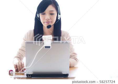 Young woman speaking English on a computer Young woman speaking English on a computer 58257724