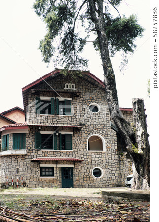 French architecture of ancient stone house with green wooden window and door at Da Lat French architecture of ancient stone house with green wooden window and door at Da Lat 58257836