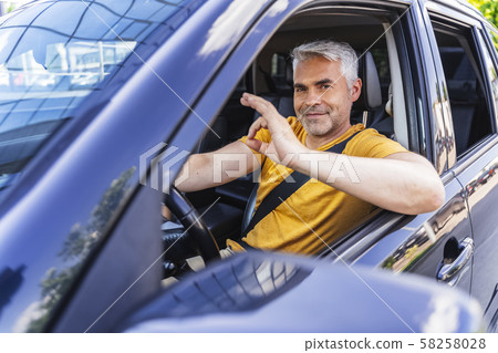 Handsome Caucasian man is posing for camera Handsome Caucasian man is posing for camera 58258028