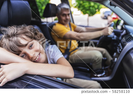 Happy Caucasian cute boy travelling by car 58258110