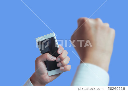 A person with a smartphone in his hand is surprised or happy. Successful business, winning a lottery ticket 58260216