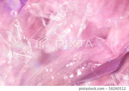 Holographic background in the style of the 80-90s. Real texture of cellophane film in bright acid Holographic background in the style of the 80-90s. Real texture of cellophane film in bright acid 58260512