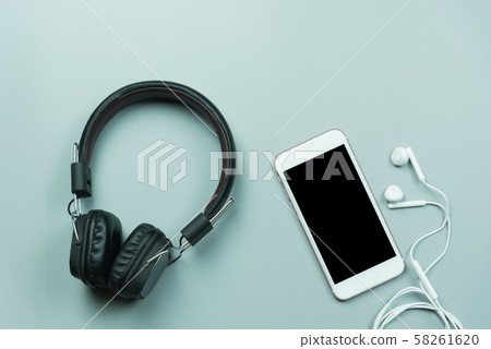 mobile and earphones on gray background mobile and earphones on gray background 58261620