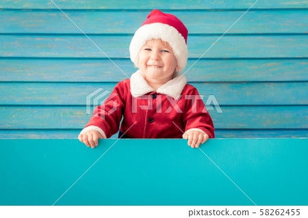 Happy child holding blue Christmas banner blank 58262455