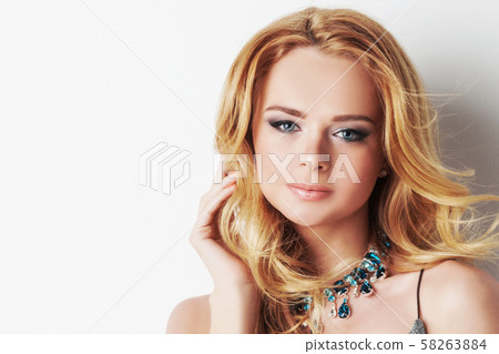 Woman with blonde curly hair and necklace Woman with blonde curly hair and necklace 58263884