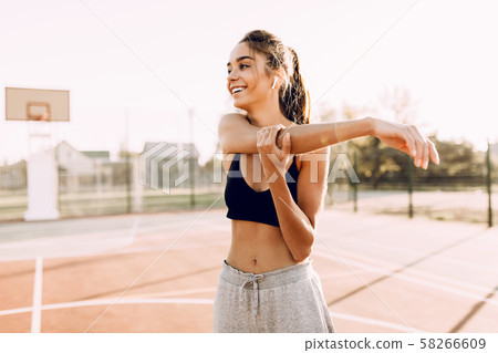 Attractive young athletic girl in sportswear doing Attractive young athletic girl in sportswear doing 58266609