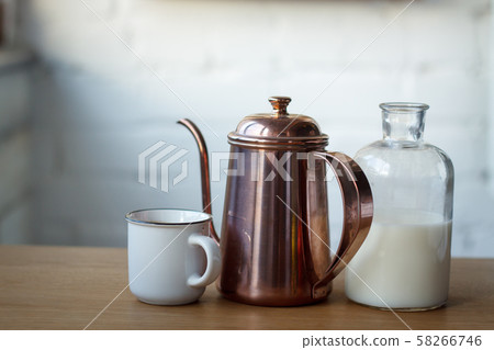 Close-up coffee cup, copper coffee pot and a Close-up coffee cup, copper coffee pot and a 58266746
