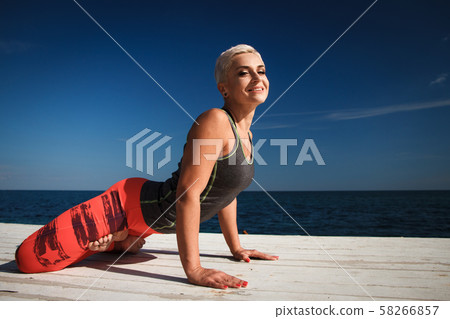 Close-up portrait of adult blond woman with short Close-up portrait of adult blond woman with short 58266857