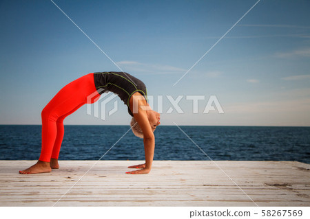 Adult blond woman with short haircut practices 58267569