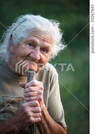 A close-up portrait of an old woman with gray hair A close-up portrait of an old woman with gray hair 58267683