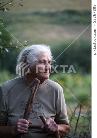 Portrait of an old woman with arthritic feet 58267898