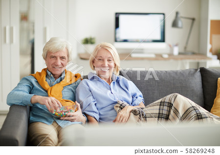 Modern Senior Couple Watching TV Modern Senior Couple Watching TV 58269248