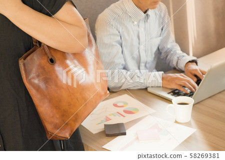 Female office worker returning home with a colleague working overtime 58269381