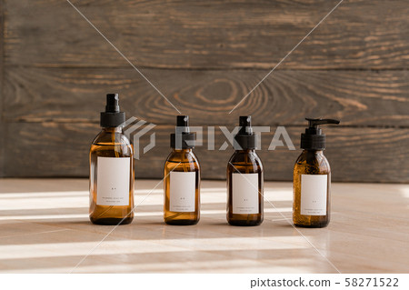 Cosmetic dark amber bottles on wooden  table 58271522