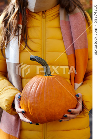 Woman holding orange pumpkin, fall concept Woman holding orange pumpkin, fall concept 58274210